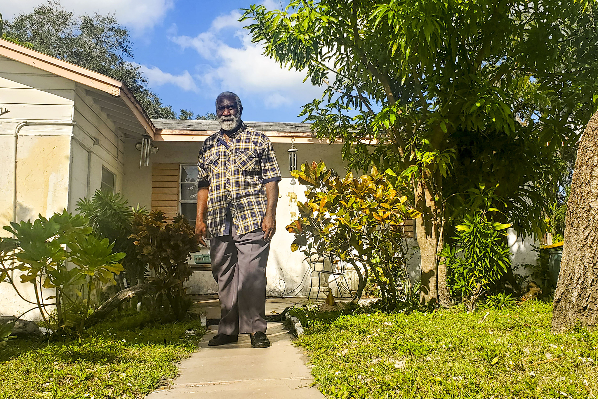 Fredd Atkins stands in front of his childhood home in Newtown. The house was built during the earliest phases of the neighborhood, and was one of the first concrete structures in the area, according to Atkins. His family still owns and rents out the house to members of the community. January 2, 2023.